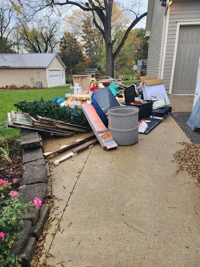 Dumpster being loaded with debris for Commercial Dumpster Rental in St. Albans